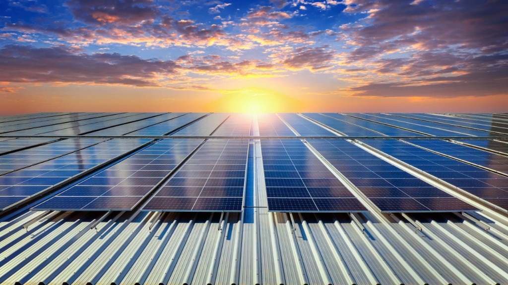 Commercial solar panels on rooftop at sunset